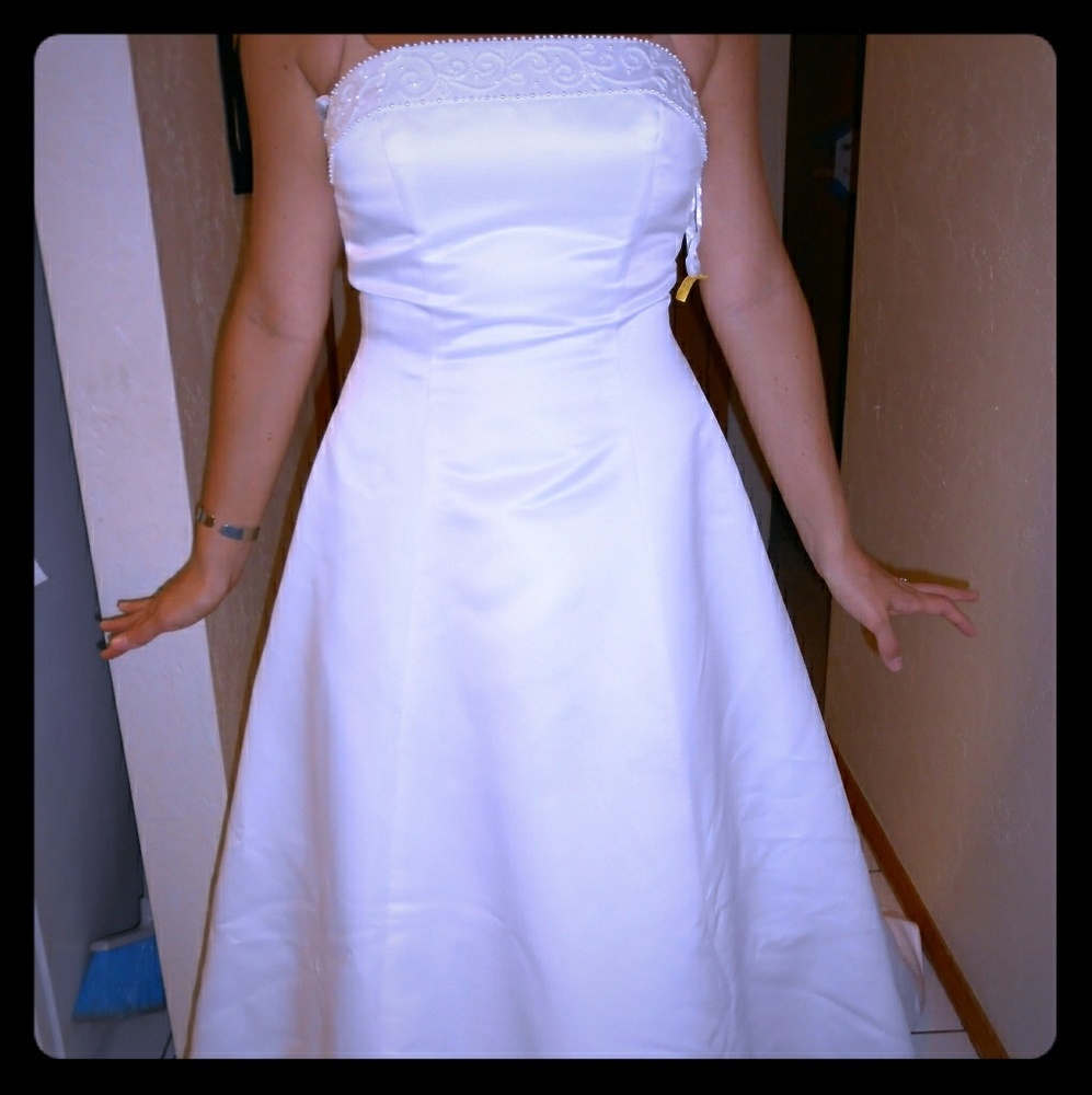 Strapless wedding dress with three tier veil.